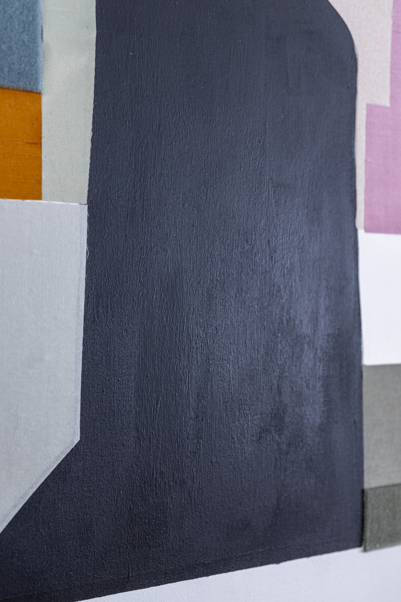 Detail of layered fabrics and a woman’s silhouette.