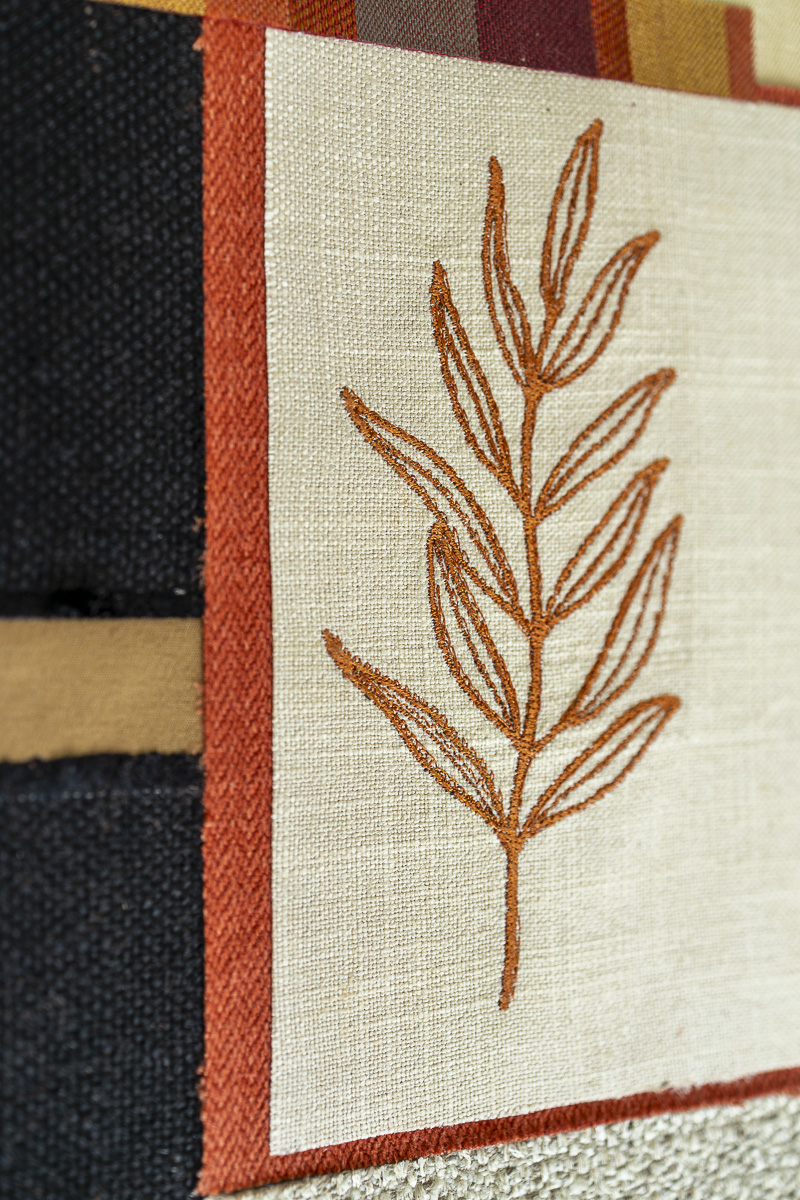 Layered reclaimed upholstery fabrics and embroidery details from the Tropic Grid series 