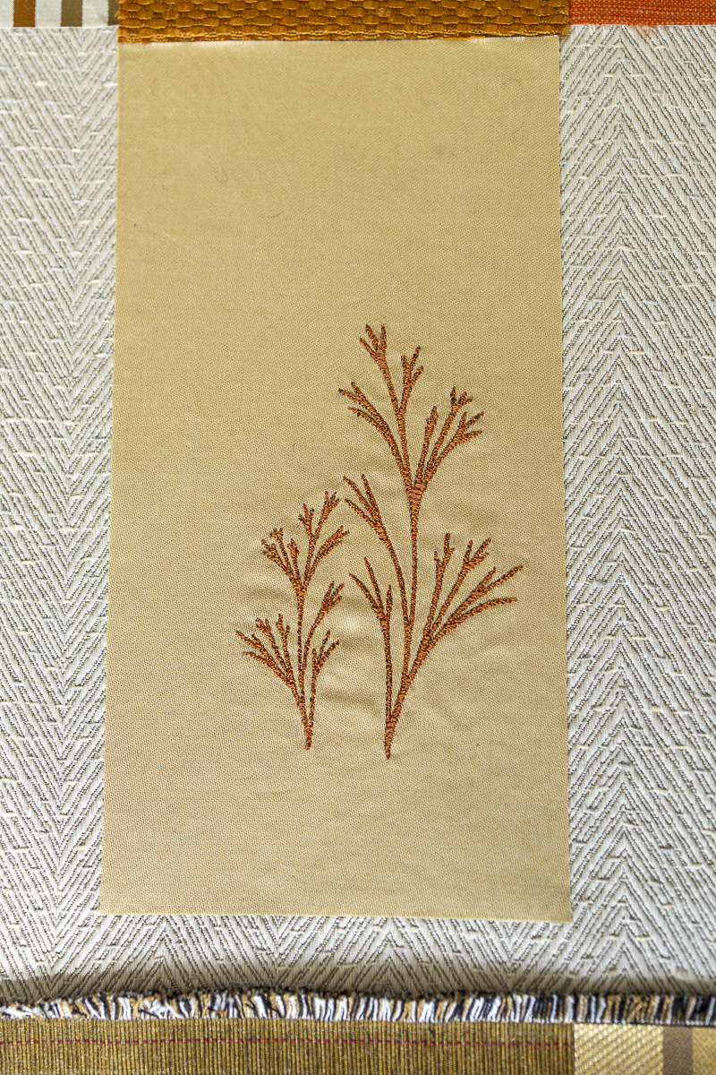 Hand-stitched fragments of surplus textiles assembled into upcycled wall panels