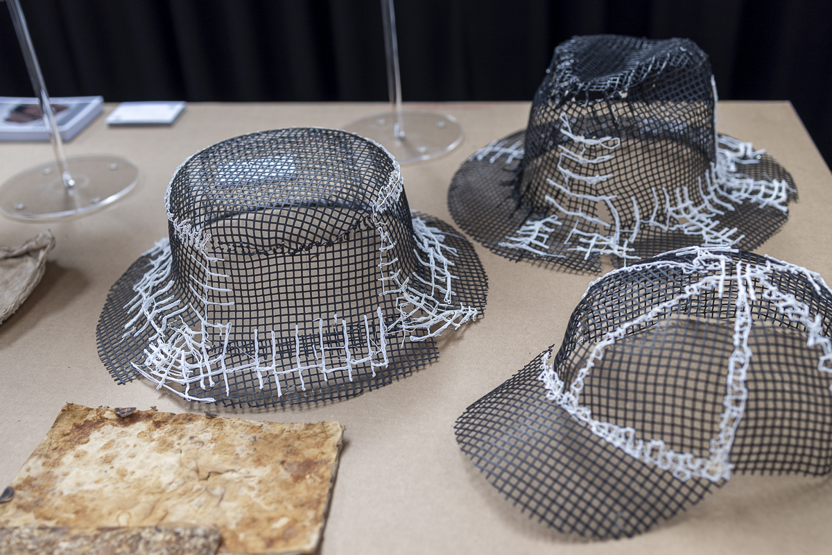 Mycelium material prototypes with an open mesh structure and textile stitching, presented as an experiment with materials in office design.