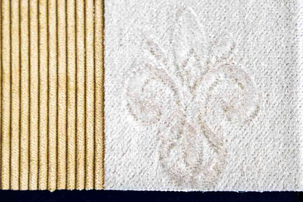 Historic fleur-de-lis motif in woven textile